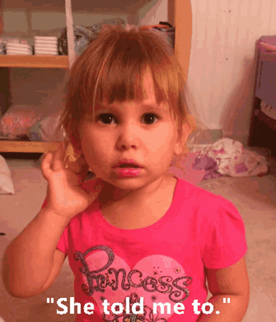 a little girl is wearing a pink shirt that says princess