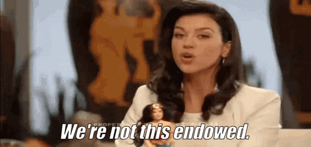 a woman is holding a barbie doll and says we 're not this endowed