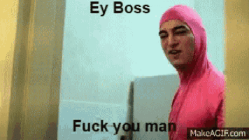 a man in a pink suit is standing in front of a wall and says `` ey boss fuck you man '' .