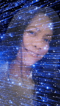 a girl is standing in front of a blue background with a lot of stars .