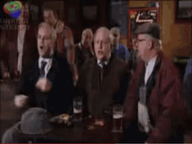 a blurred image of a group of people in a bar with a sign that says philips stereo in the background