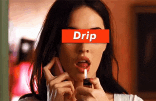 a woman is applying lip gloss with a red drip label on her face
