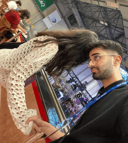a man wearing a lanyard that says ' istanbul 2011 ' on it