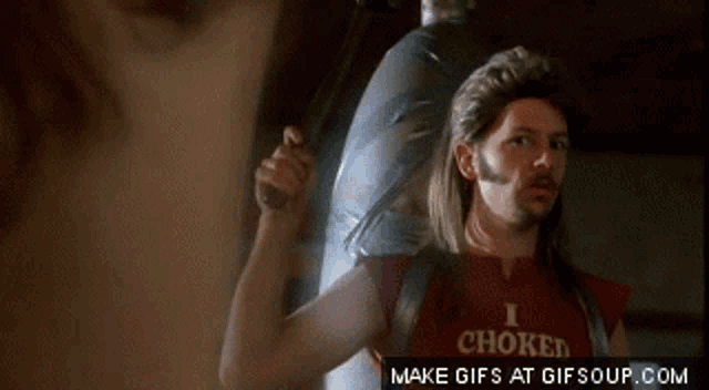 a man with long hair and a beard is wearing a red shirt that says i choked