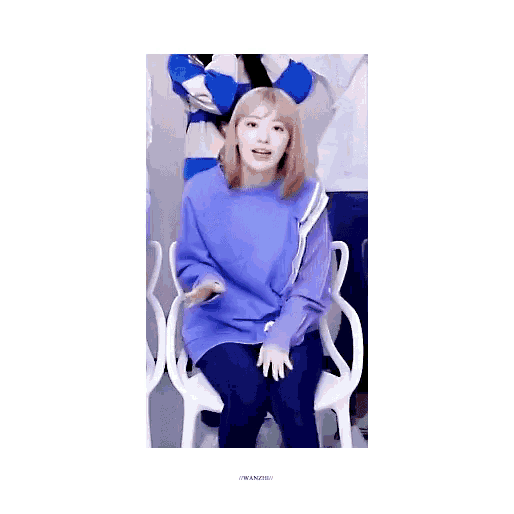 a girl in a purple shirt is sitting in a chair