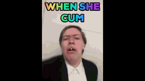 a man in a suit and white shirt is making a funny face with the caption when she cum