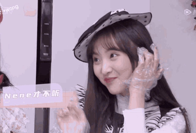 a girl wearing a hat and plastic gloves says nene on the bottom left