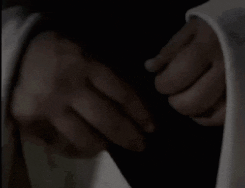 a close up of a person 's hand holding a white cloth .