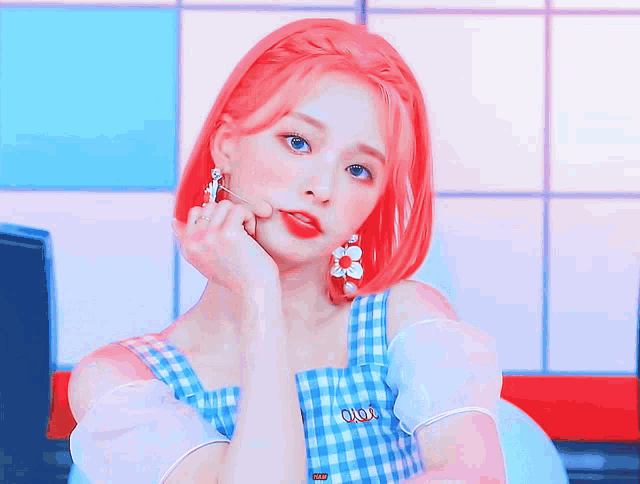 a girl with red hair is wearing a blue and white dress