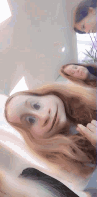 a girl with long hair looks at the camera