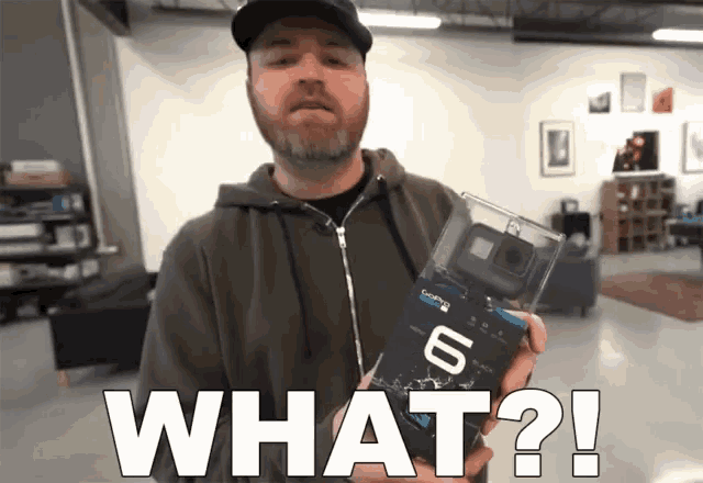 a man is holding a gopro 6 in a clear box and asking what