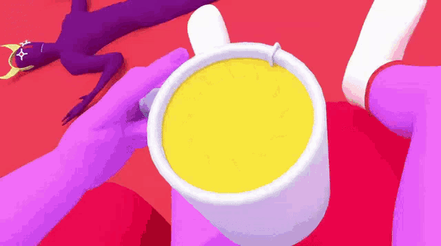 a person is holding a cup of yellow liquid with a spoon in it