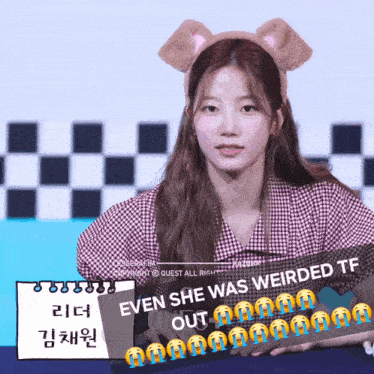 a girl wearing a headband that says even she was weirded tf on it
