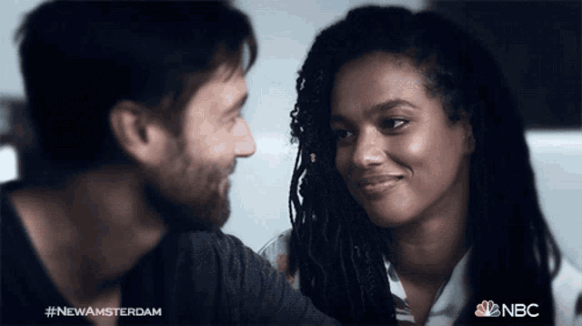 a man and a woman are looking into each other 's eyes with the hashtag #newamsterdam