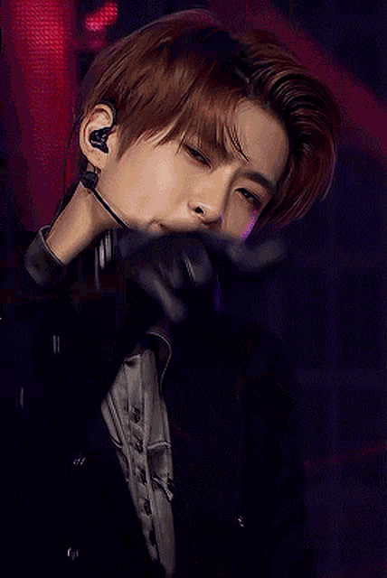a close up of a man wearing a microphone and gloves .