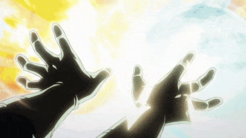 a person 's hands are reaching out towards a light