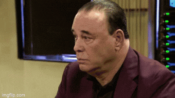a man in a purple suit is looking at something