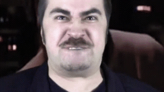 a man with a mustache is making a face