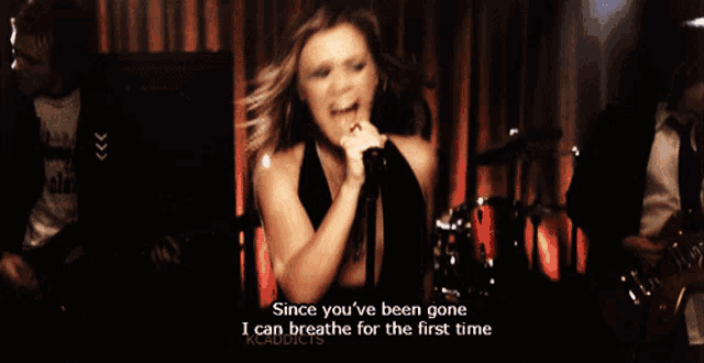 a woman singing into a microphone with the words " since you 've been gone i can breathe for the first time "