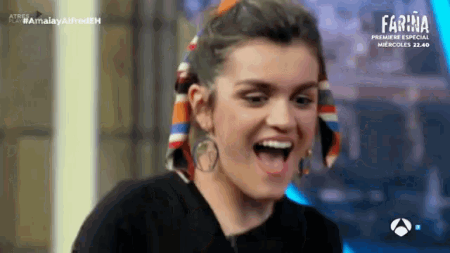 a woman is laughing in front of a screen that says farina on it