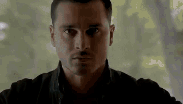 a close up of a man 's face looking at the camera .