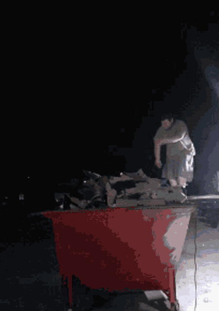 a person is standing in the dark with a light coming from behind them