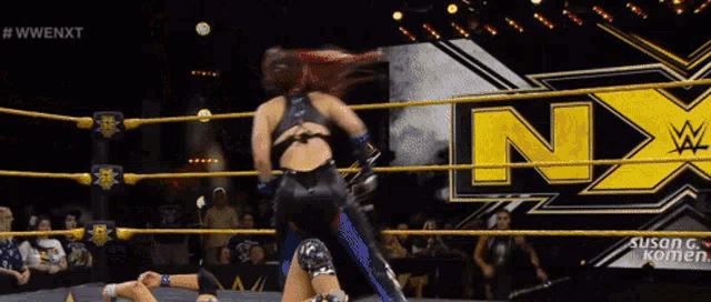 a woman in a wrestling ring with the letters nx on the ring