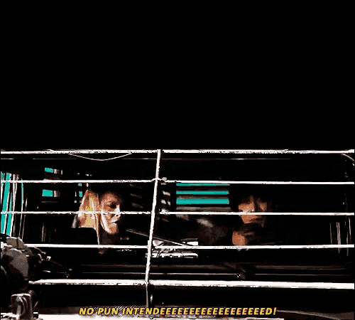 a man and a woman are sitting in a cage and the woman is saying no pun intended