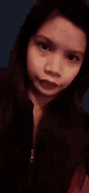 a close up of a woman 's face with red lipstick on her lips .