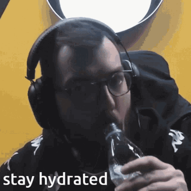 a man wearing headphones and glasses drinking from a bottle with the words stay hydrated written below him
