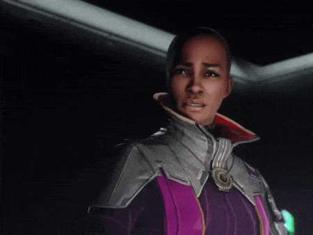 a woman in a purple jacket with the word cowardice written on it