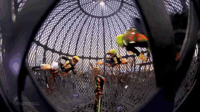 a group of people in a cage with the word insomniac on the bottom left