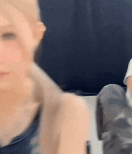 a blurry picture of a woman 's face and shoulder