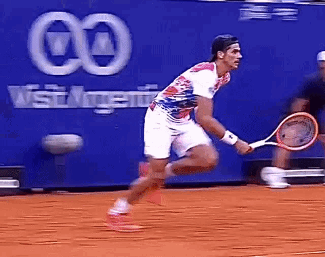 a man is running with a tennis racket in his hand