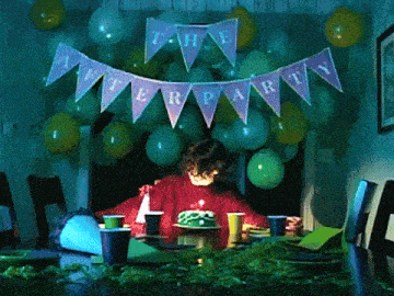 a girl sitting at a table with a birthday cake and a banner that says the after party