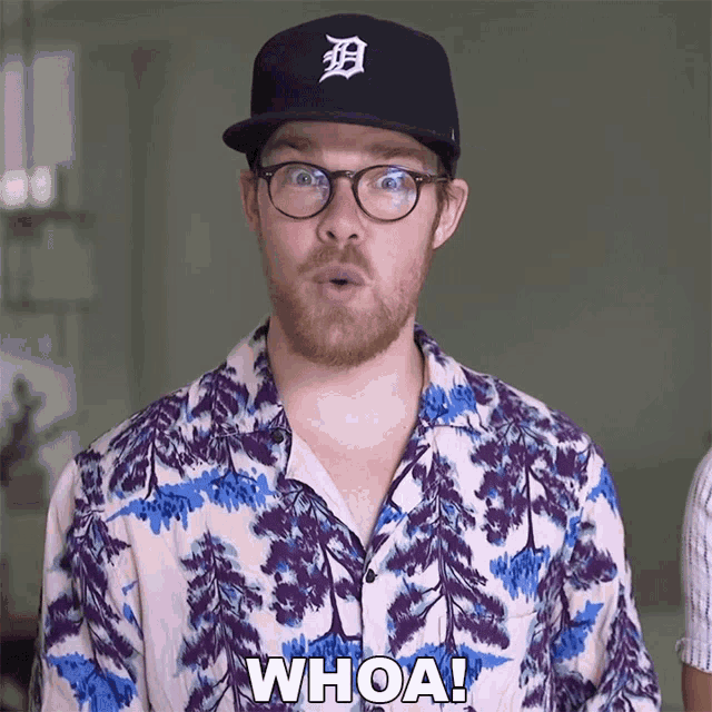 a man wearing a tigers hat and glasses is saying whoa