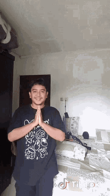 a man wearing a black shirt that says tiktok on the bottom