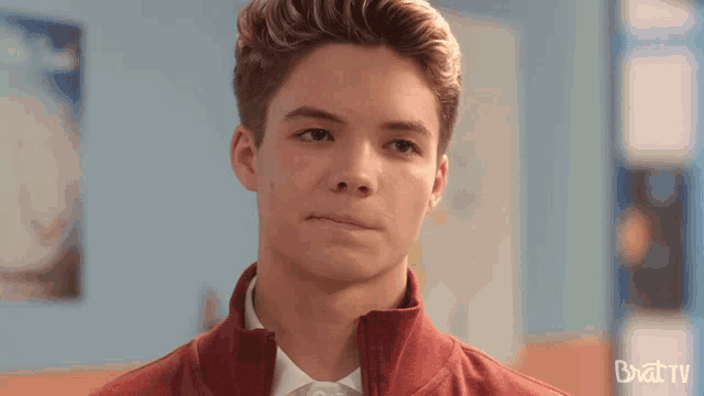 a close up of a young man 's face with the words bratv written on the bottom