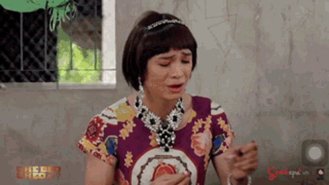 a woman wearing a headband and a necklace with the word spa on it