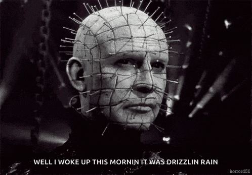 a black and white photo of a man with pins in his head and the words `` well i woke up this morning it was drizzlin rain ''