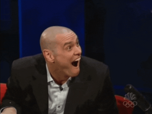 a man in a suit and white shirt is clapping in front of a cnbc logo