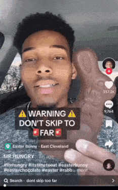 a man in a car holding a chocolate easter bunny with a warning sticker on it