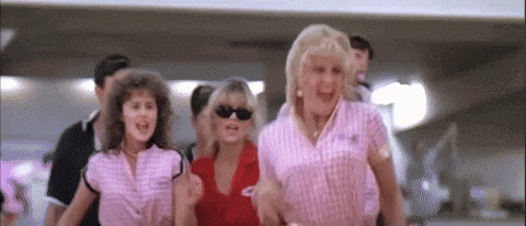 a group of women wearing sunglasses are walking together .