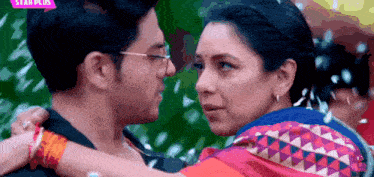 a man and a woman are hugging and looking at each other with a star plus logo behind them