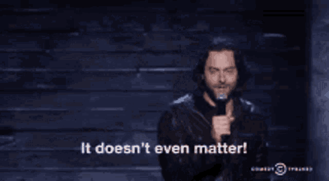 a man speaking into a microphone with the words it does n't even matter