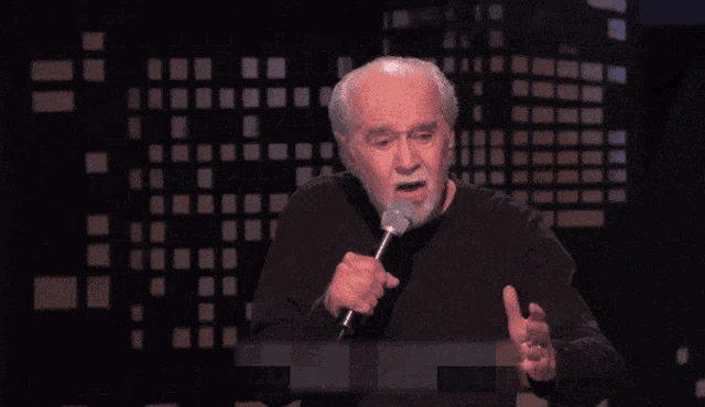 a man speaking into a microphone with the words " they don 't care about you "