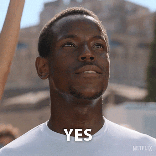 a man in a white shirt with the word yes on his chest