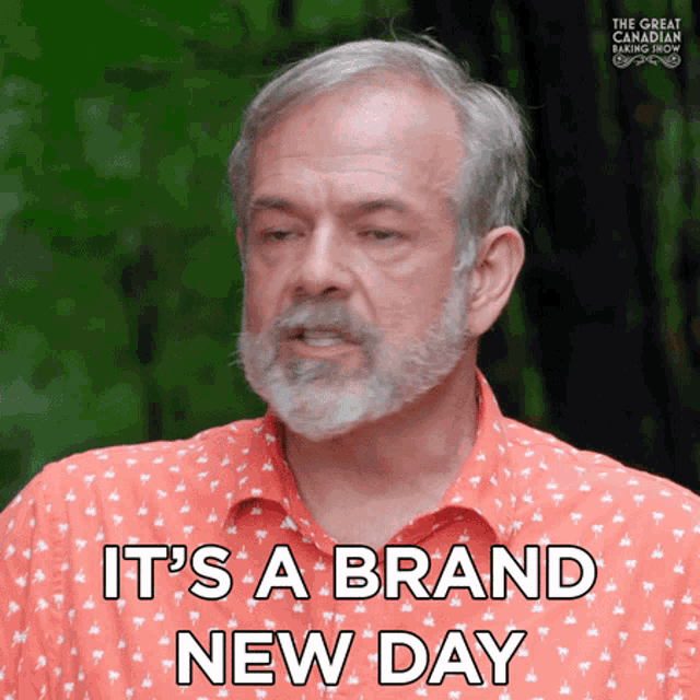 a man with a beard is wearing an orange shirt and says it 's a brand new day