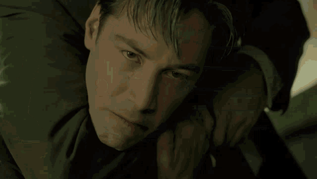 a man in a gray shirt is crawling on the ground .