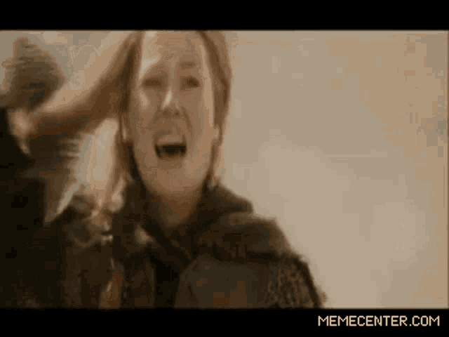 a woman is screaming with her mouth open in a video .